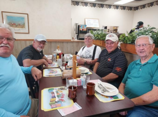 Group of men eating breakfast at a restaurant